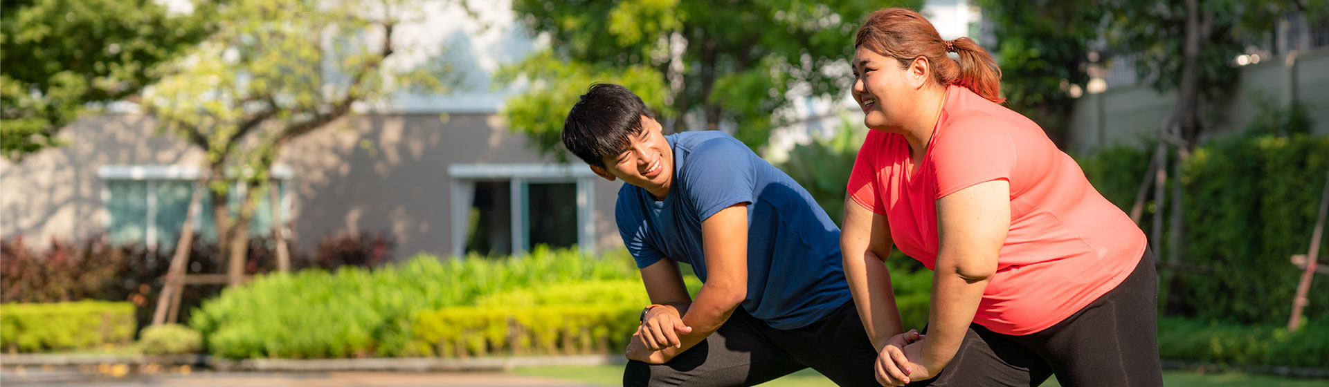 Woman exercising with trainer outdoors